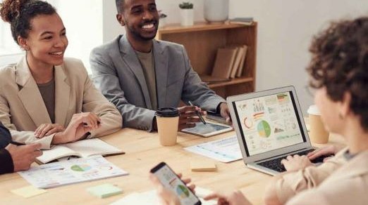 colleagues in a meeting laughing